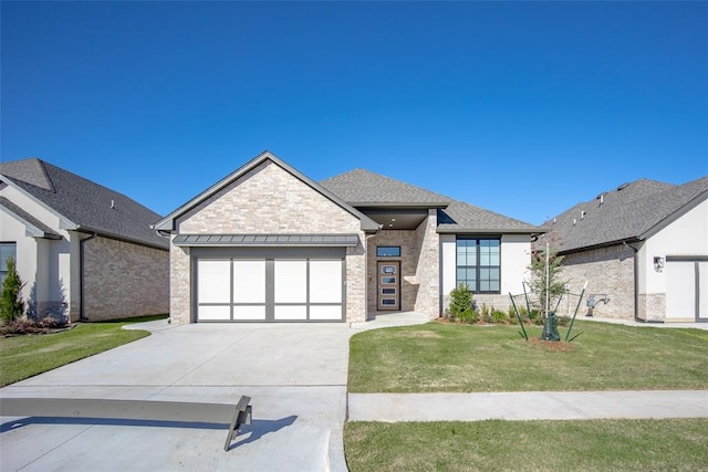 view of front facade with a garage and a front yard