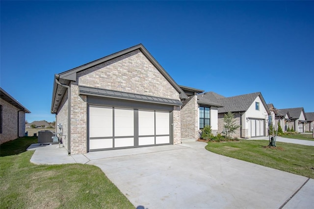 view of front of home with a garage, a front lawn, and central air condition unit