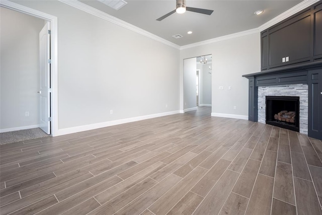 unfurnished living room with a fireplace, crown molding, hardwood / wood-style floors, and ceiling fan with notable chandelier