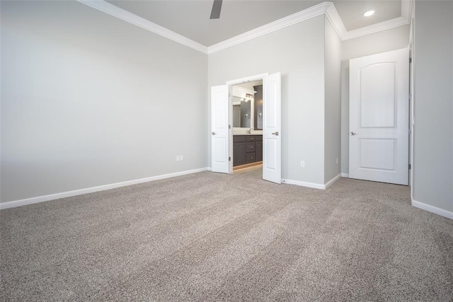 unfurnished bedroom with ensuite bath, ceiling fan, crown molding, and carpet floors