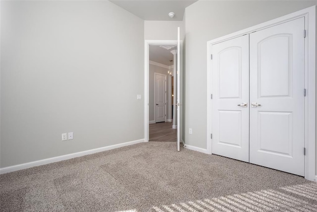 unfurnished bedroom featuring carpet flooring and a closet