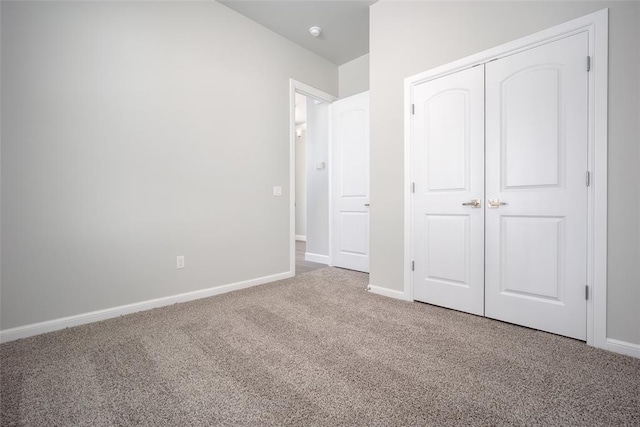 unfurnished bedroom featuring carpet and a closet