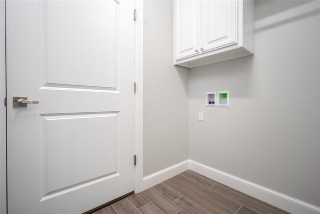 laundry area featuring hardwood / wood-style flooring, cabinets, and washer hookup