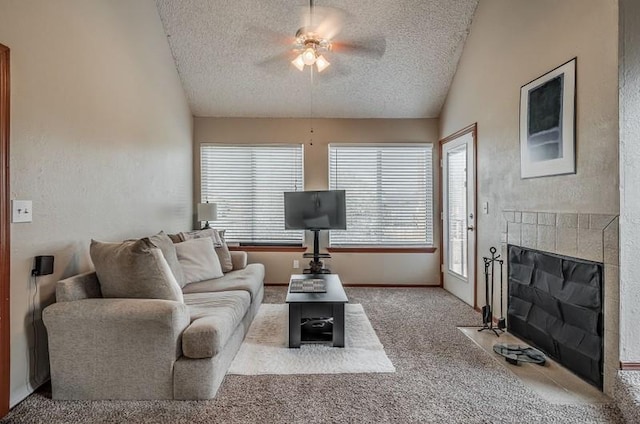 carpeted living room with plenty of natural light, ceiling fan, lofted ceiling, and a textured ceiling