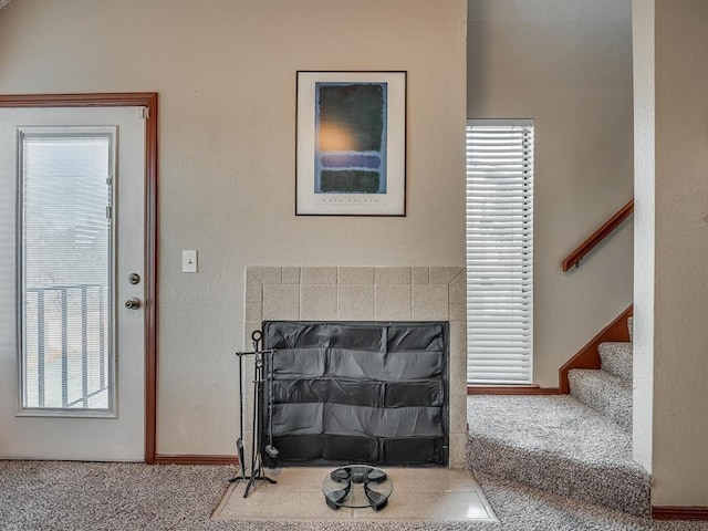 entrance foyer with carpet flooring and a healthy amount of sunlight