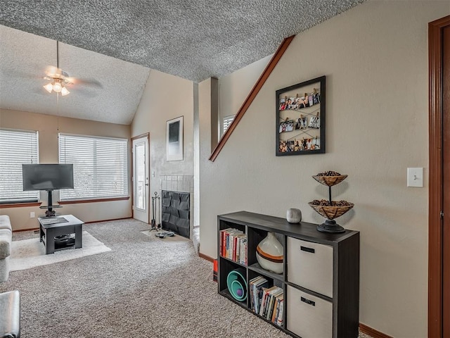 living room with carpet flooring, ceiling fan, a textured ceiling, and vaulted ceiling