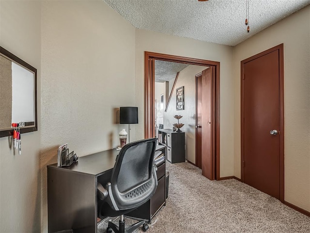 home office with a textured ceiling and light colored carpet