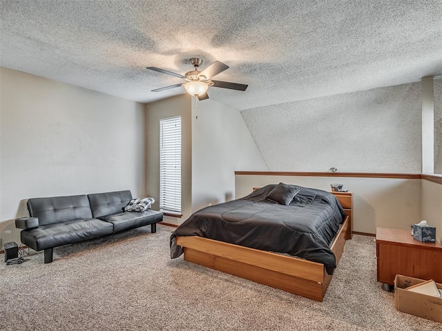 carpeted bedroom featuring ceiling fan, a textured ceiling, and vaulted ceiling