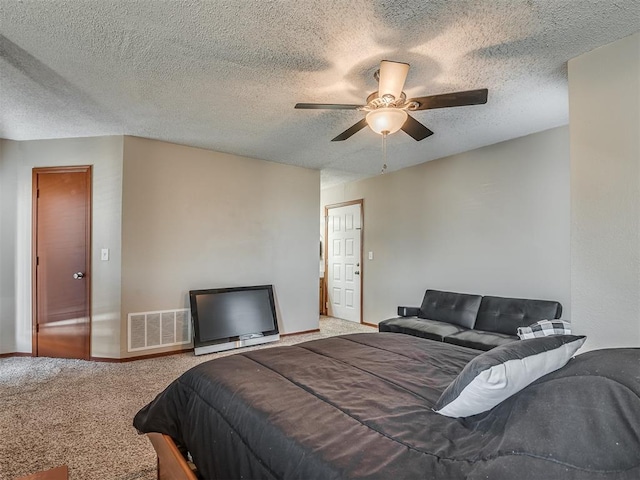 bedroom featuring carpet flooring, ceiling fan, and a textured ceiling