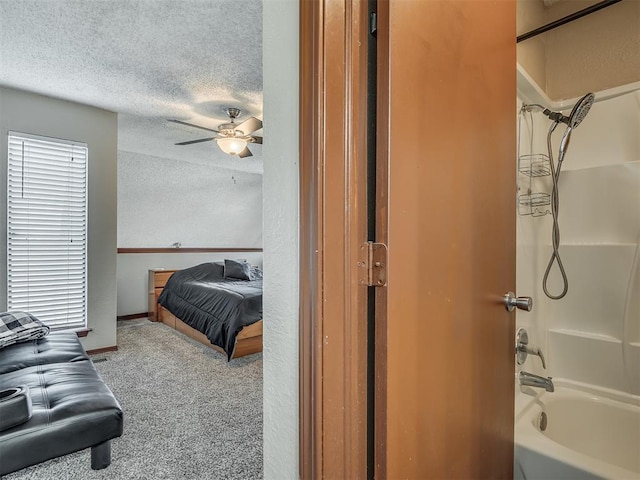 bedroom with carpet flooring, ceiling fan, and a textured ceiling