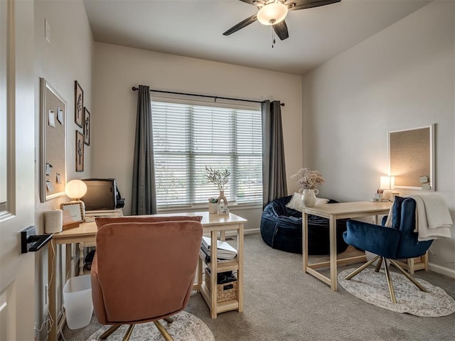 carpeted office space with ceiling fan