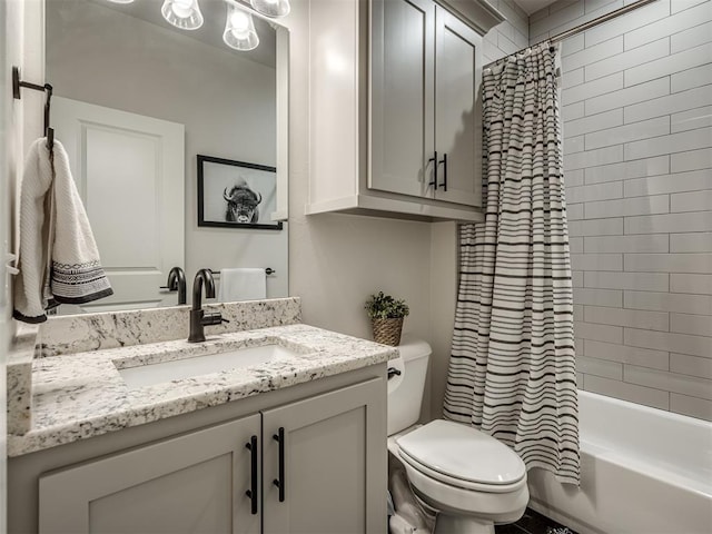 full bathroom featuring toilet, vanity, and shower / bath combo with shower curtain