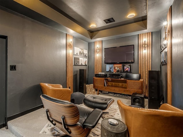 carpeted cinema featuring a tray ceiling