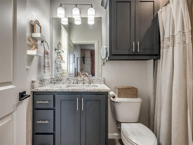 bathroom featuring toilet and vanity