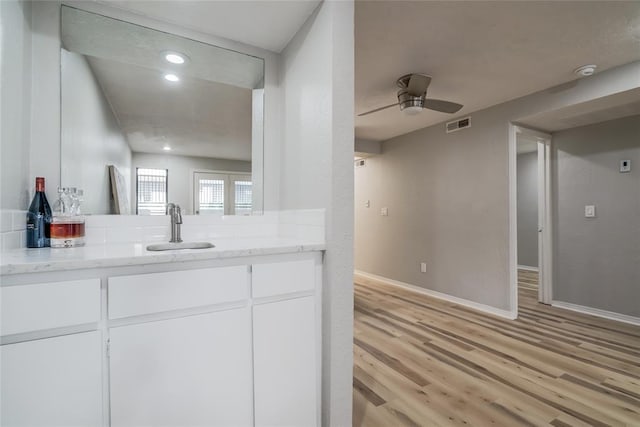 bathroom featuring wood-type flooring, vanity, and ceiling fan