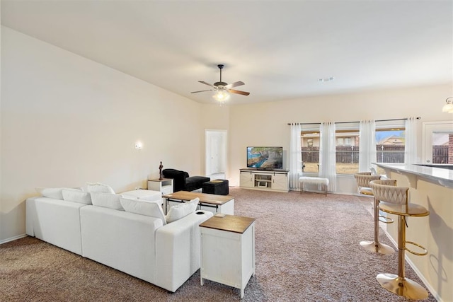 carpeted living room featuring ceiling fan