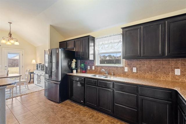 kitchen featuring decorative backsplash, stainless steel fridge, vaulted ceiling, sink, and black dishwasher