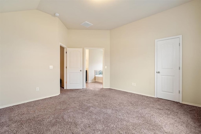 unfurnished bedroom with carpet flooring and lofted ceiling