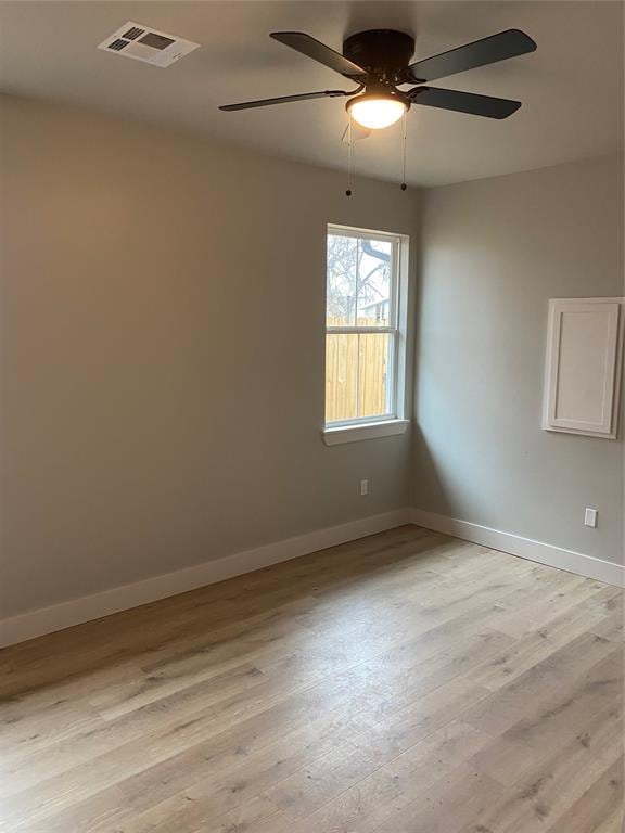 spare room with ceiling fan and light hardwood / wood-style flooring