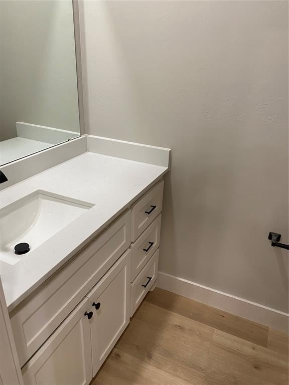 bathroom with vanity and hardwood / wood-style floors