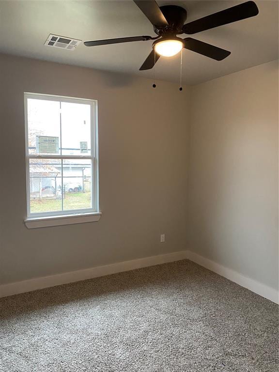 spare room featuring carpet flooring and ceiling fan