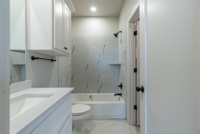 full bathroom featuring toilet, vanity, and tiled shower / bath combo