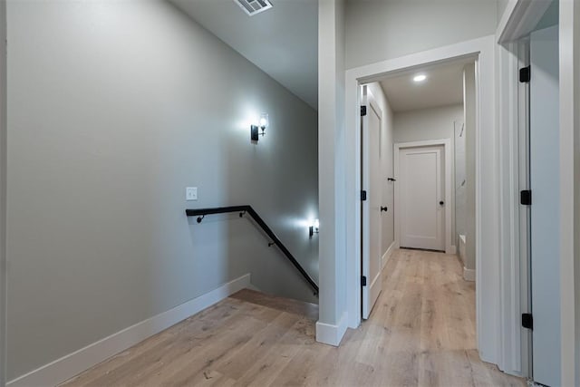 stairs featuring hardwood / wood-style floors