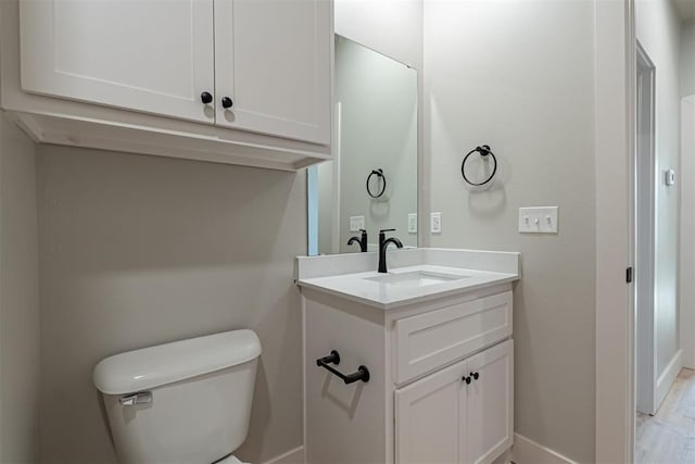 bathroom featuring toilet and vanity