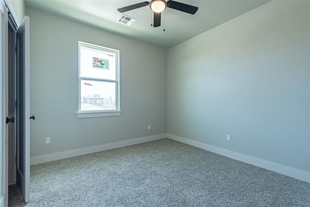 spare room featuring carpet and ceiling fan