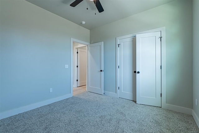 unfurnished bedroom with a closet, ceiling fan, and light colored carpet