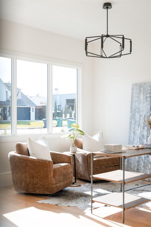 sitting room with a chandelier and light hardwood / wood-style floors