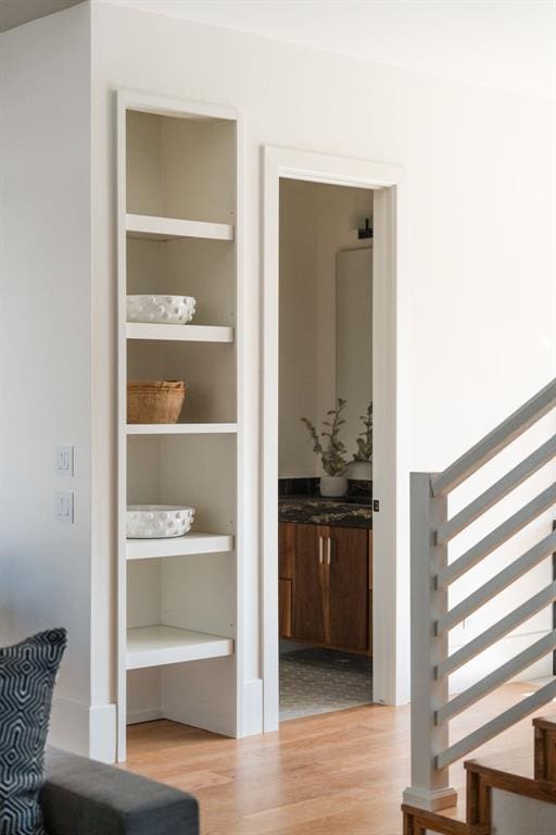 interior space with built in shelves and light wood-type flooring