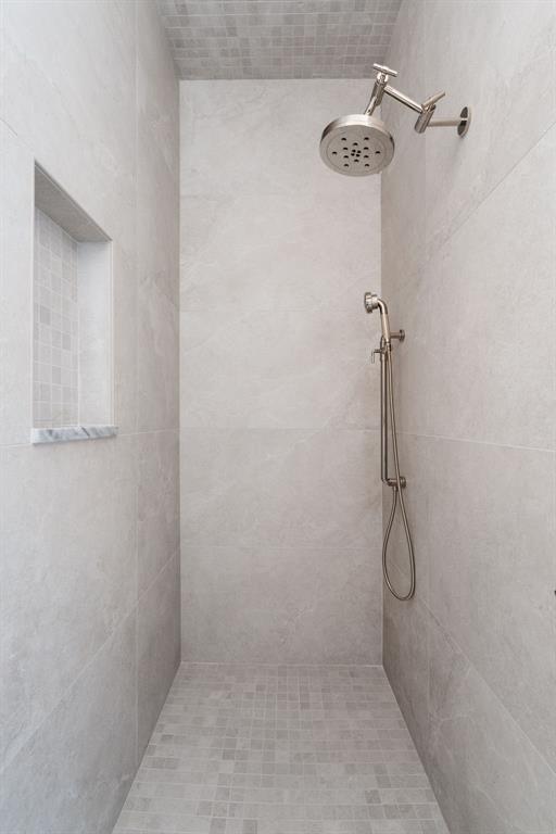 bathroom with tiled shower