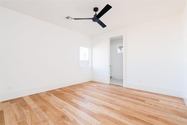 unfurnished room featuring ceiling fan and hardwood / wood-style floors