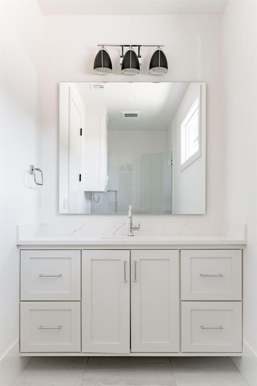 bathroom with vanity and a shower with shower door