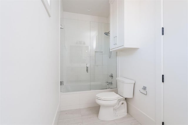 bathroom with enclosed tub / shower combo and toilet