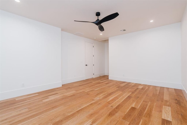 empty room featuring ceiling fan and light hardwood / wood-style floors