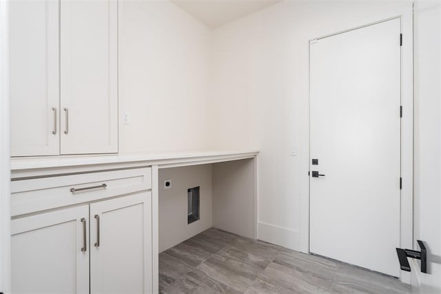 clothes washing area with cabinets and electric dryer hookup