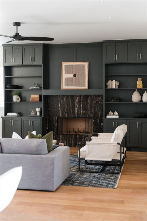 living room with hardwood / wood-style flooring and a high end fireplace