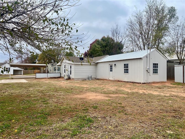 rear view of property with a lawn