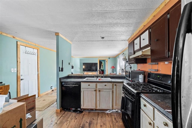 kitchen with crown molding, sink, black appliances, and light hardwood / wood-style flooring