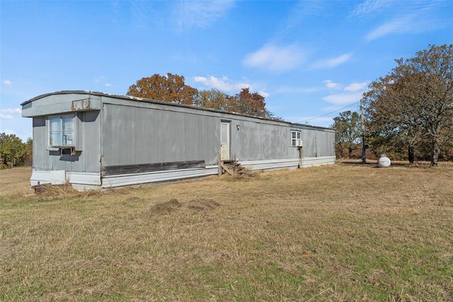 view of side of home with a lawn