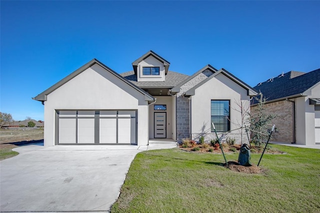 view of front of home with a front lawn and a garage