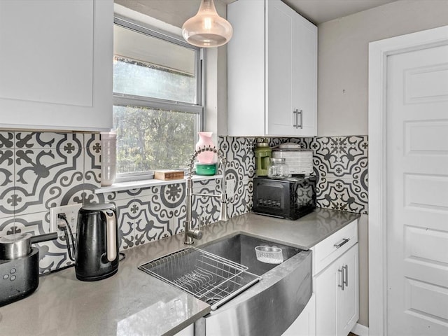 kitchen featuring decorative backsplash and white cabinetry