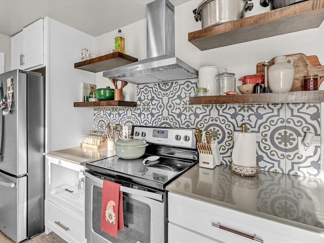 kitchen with white cabinets, appliances with stainless steel finishes, backsplash, and island range hood