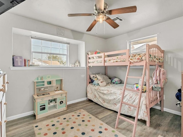 bedroom with ceiling fan and dark wood-type flooring