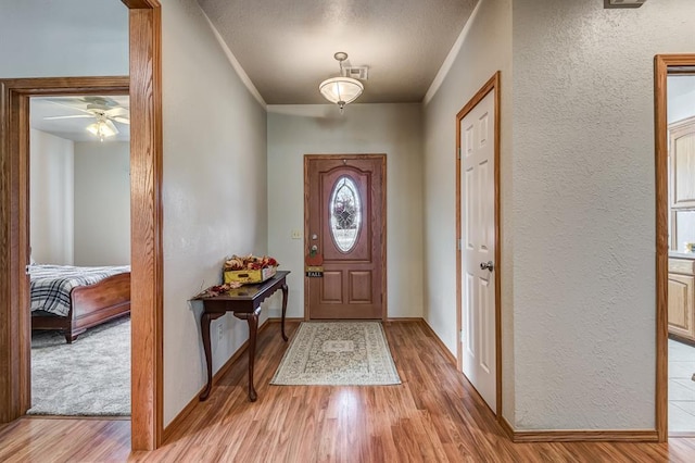 entrance foyer featuring light hardwood / wood-style flooring and ceiling fan