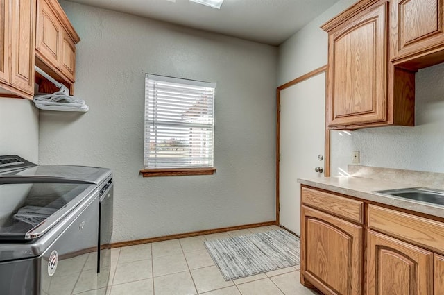 kitchen featuring light tile patterned floors and washing machine and clothes dryer