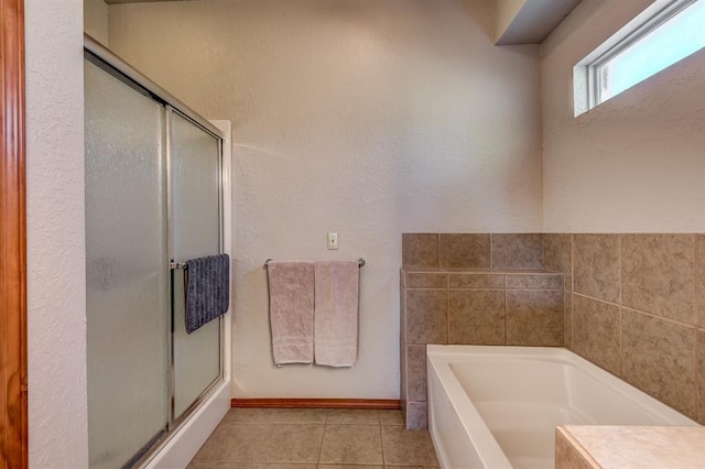 bathroom with tile patterned floors and separate shower and tub