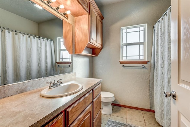 bathroom with tile patterned floors, vanity, and toilet